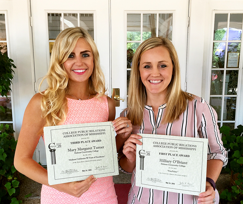 IN THIS PHOTO: (left to right) Holmes Community College Public Relations Specialists Mary Margaret Turner and Hilliary O'Briant showing two of the five awards Holmes won at the 2016 College Public Relations Association of Mississippi's (CPRAM) Conference held May 23-24 at Gulf Hills Hotel and Conference Center in Ocean Springs.