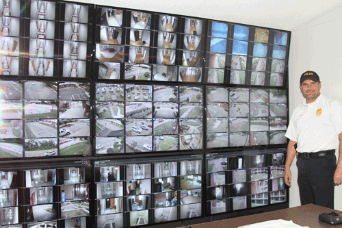 Goodman Police Chief Tony McDaniel poses with the 200 surveillance cameras now installed on the Goodman Campus.