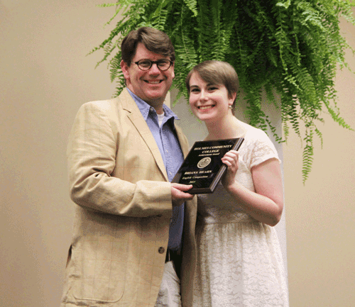 Pictured is Holmes Community College English instructor Dr. Andrew Kelly presenting the English Composition Award to Briana Hearn when she was a Holmes student in 2015. Hearn graduated from the University of Mississippi on May 12 and received the university’s highest academic award, the Marcus Elvis Taylor Memorial Medal.