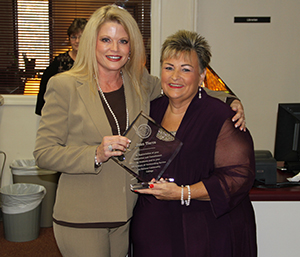 Director of Library Services Joan Estes Tierce, right, of Holcomb recently announced her retirement from Holmes Community College. Tierce was honored recently with a retirement reception in the Jack L. Holmes Library at the Grenada Campus and was presented a plaque from Vice President of Institutional Research and Student Affairs Dr. Lindy McCain.