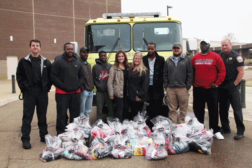 Members of the Ridgeland SkillsUSA chapters, along with advisers their advisers and representation from the Ridgeland Fire Department, pose for a photo with gifts collected for Sunnybrook Children's Home.