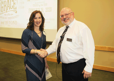 Shannon Warnock, who serves as community leader for the Mississippi Humanities Council, congratulates J.R. Hall on a successful presentation.