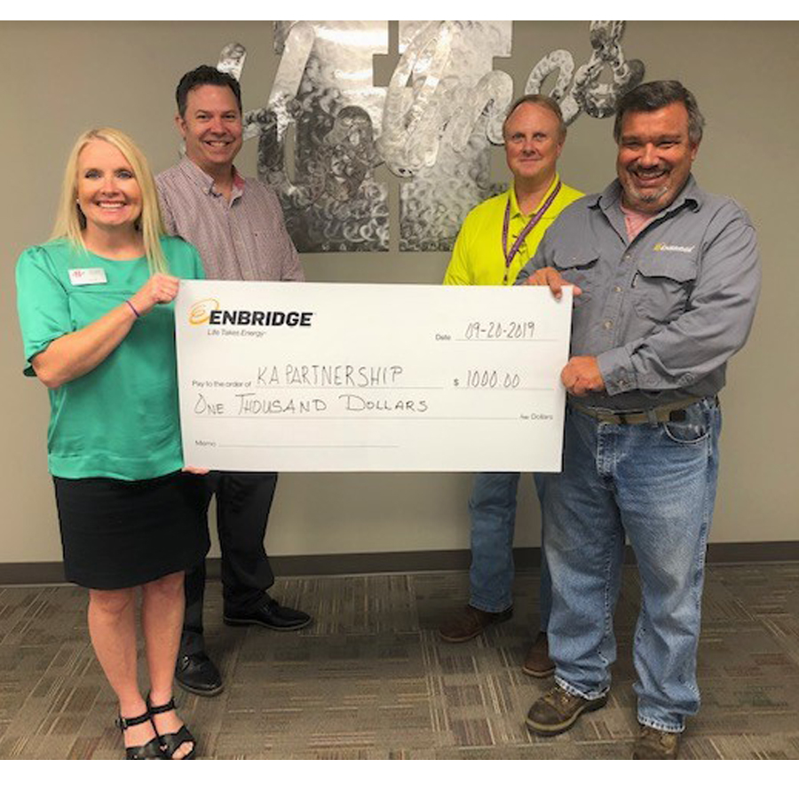 Robert Ellis of Enbridge, front right, presents to check to Mandy Burrell of Holmes, Darren Milner of the Kosciusko Attala Partnership and Tony Holder of the Career Technical Center.