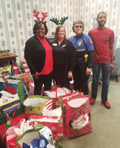 Pictured at The Home Place after delivering gifts are (left to right) Mary Haralson, Jennifer Smith, Officer Judy Tucker and student Khidari Barksdale.